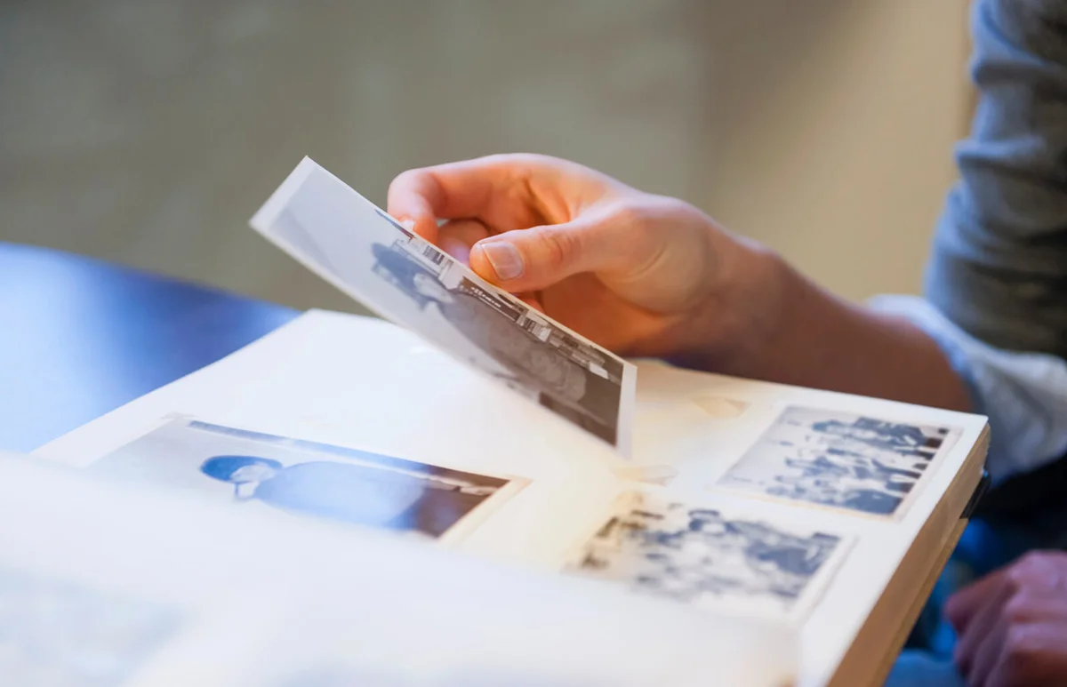 Woman holding up a photograph