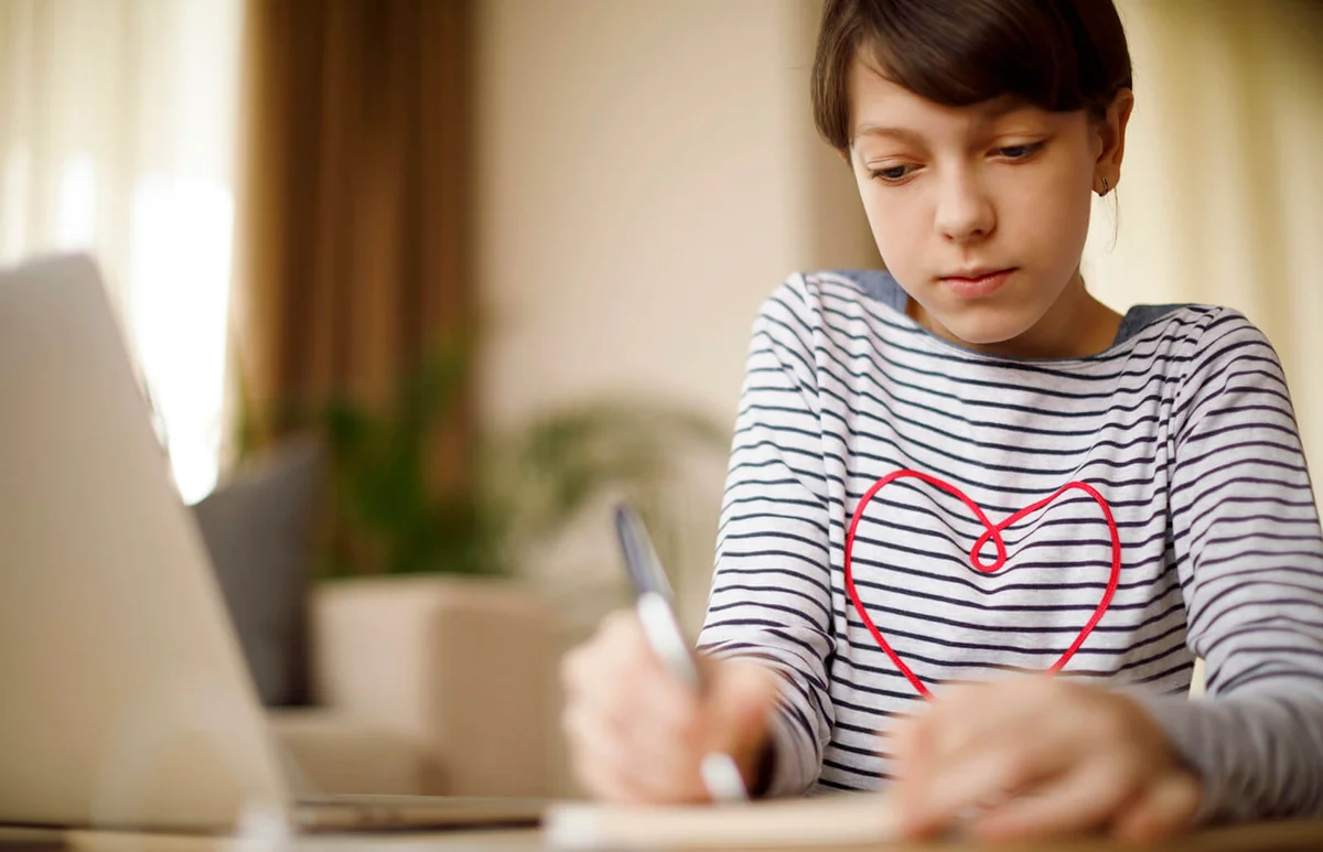 Preteen girl journaling