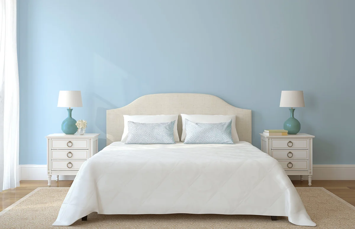 White bedroom furniture with a blue wall