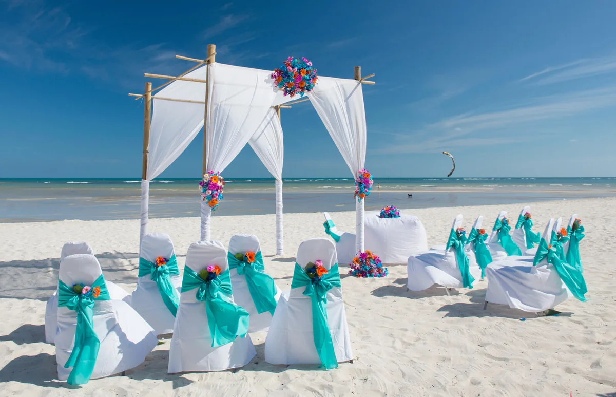 Chairs And Gazebo On Beach Against Blue Sky