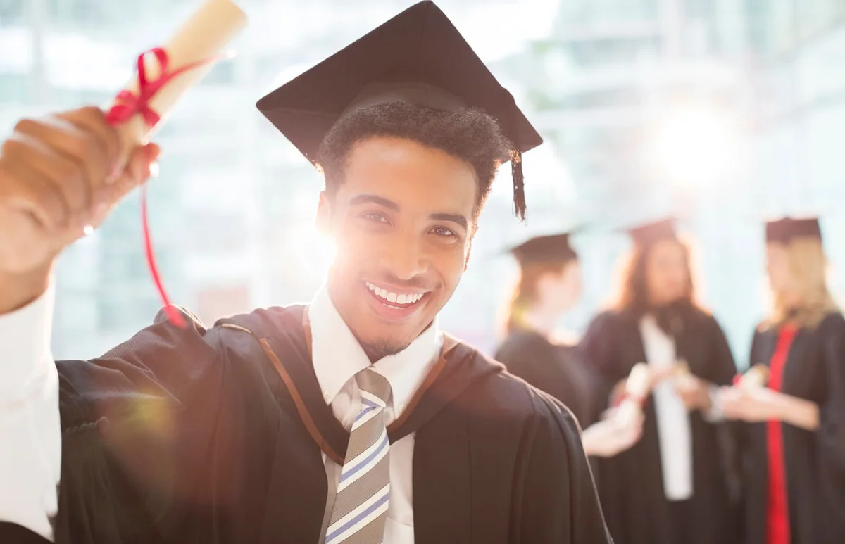Smiling graduate holding diploma
