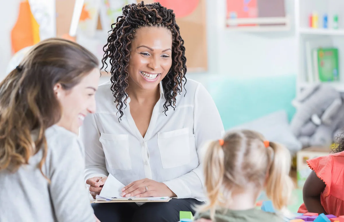 Preschool teacher holds parent teacher conferences