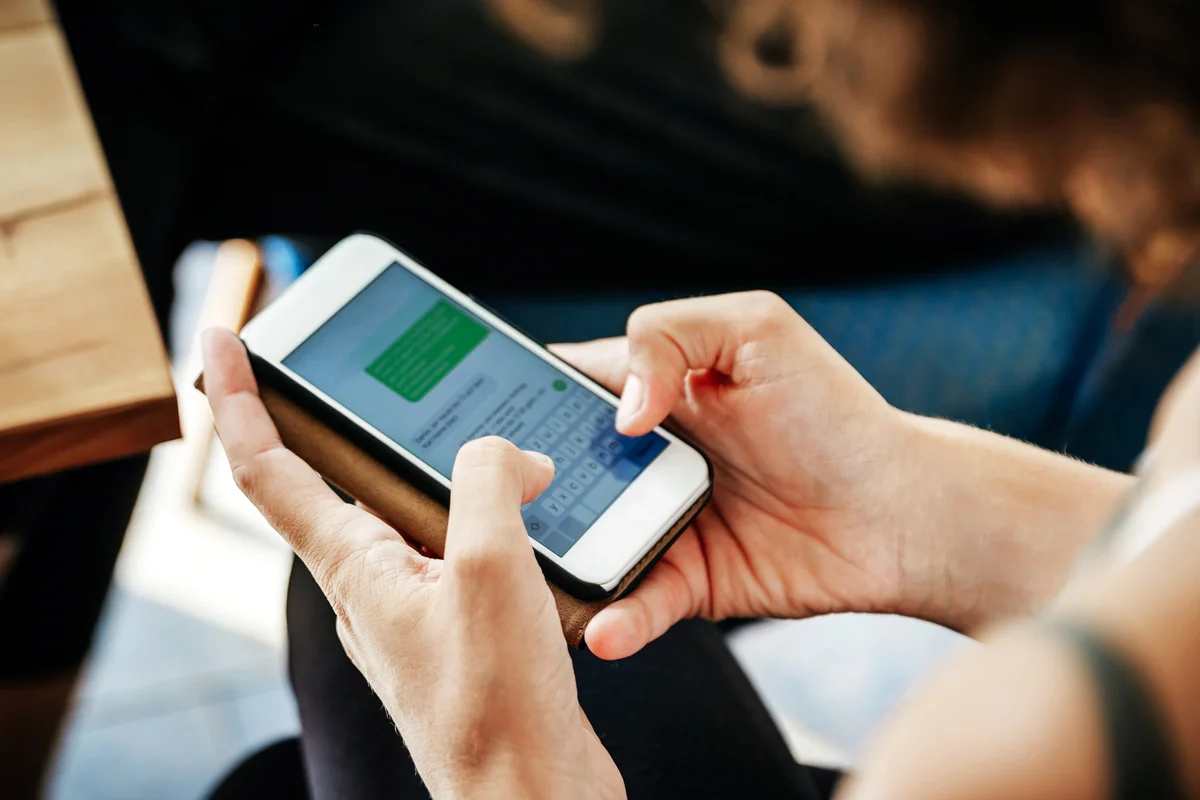 Woman Messaging Friends Using Smartphone