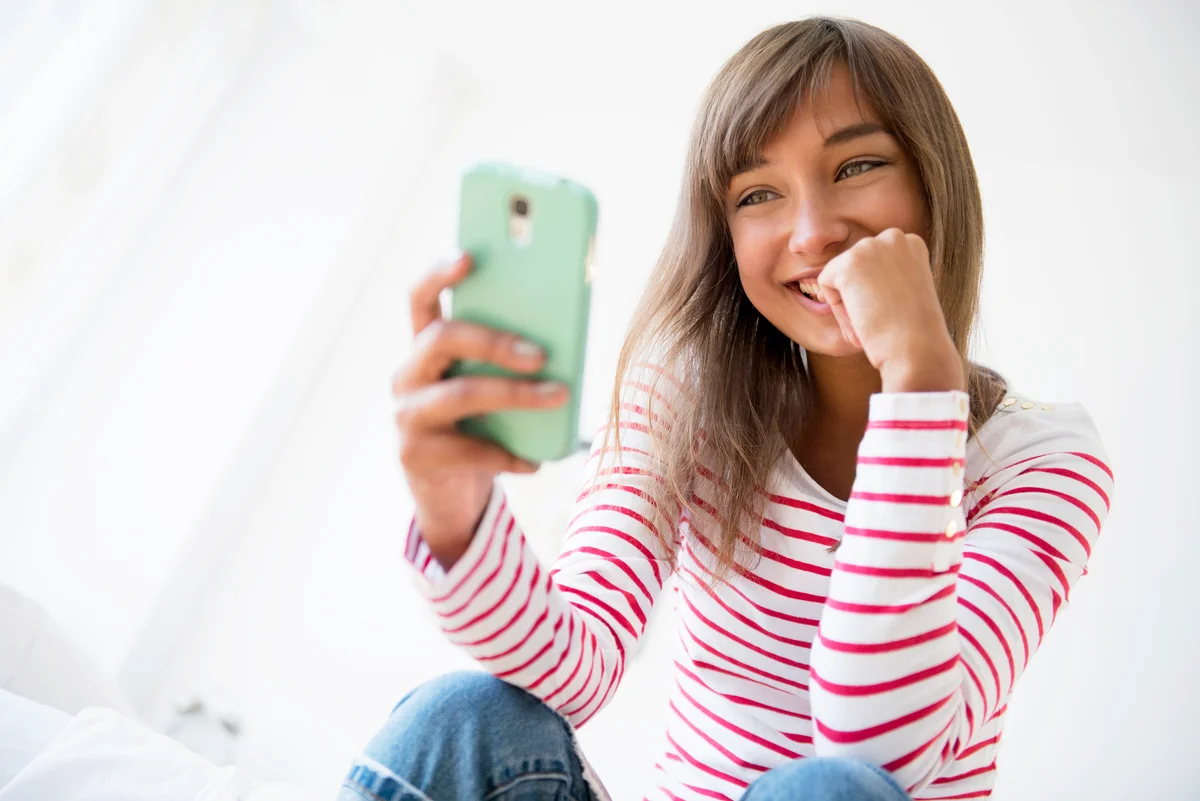 Young woman sending flirty texts
