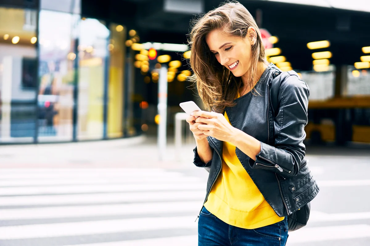 Happy woman looking at cell phone