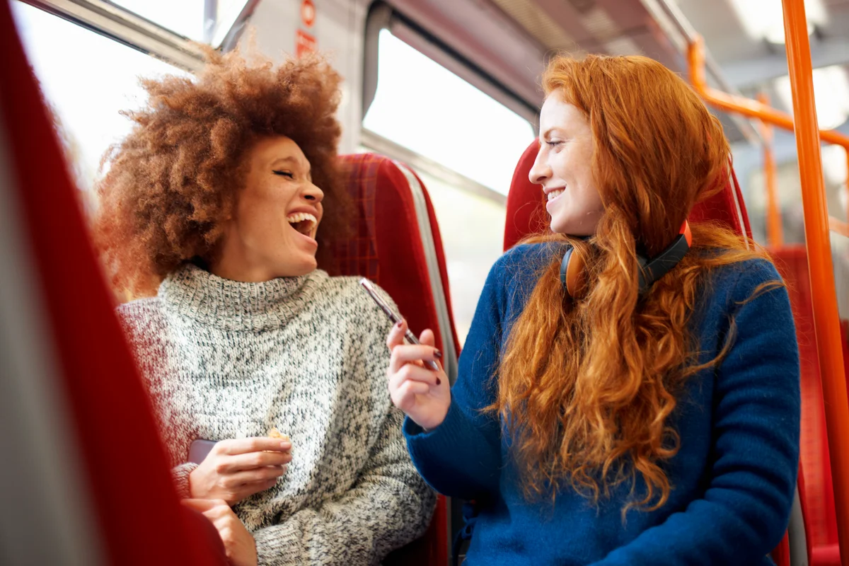 Two women talking on train
