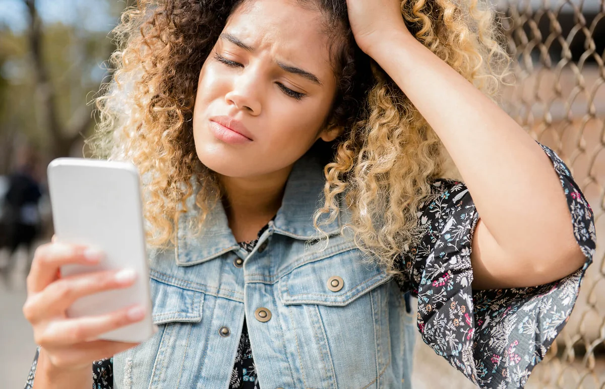 Unhappy woman texting on cell phone