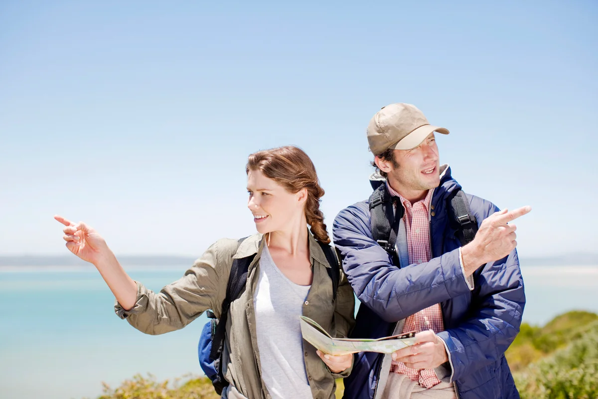 Couple hiking and pointing at different directions