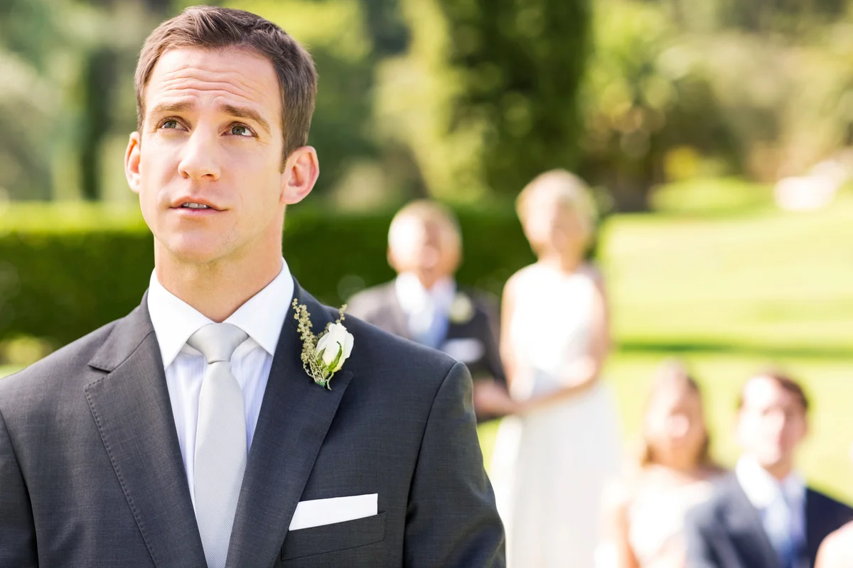 Nervous Groom Looking Up During Wedding Ceremony