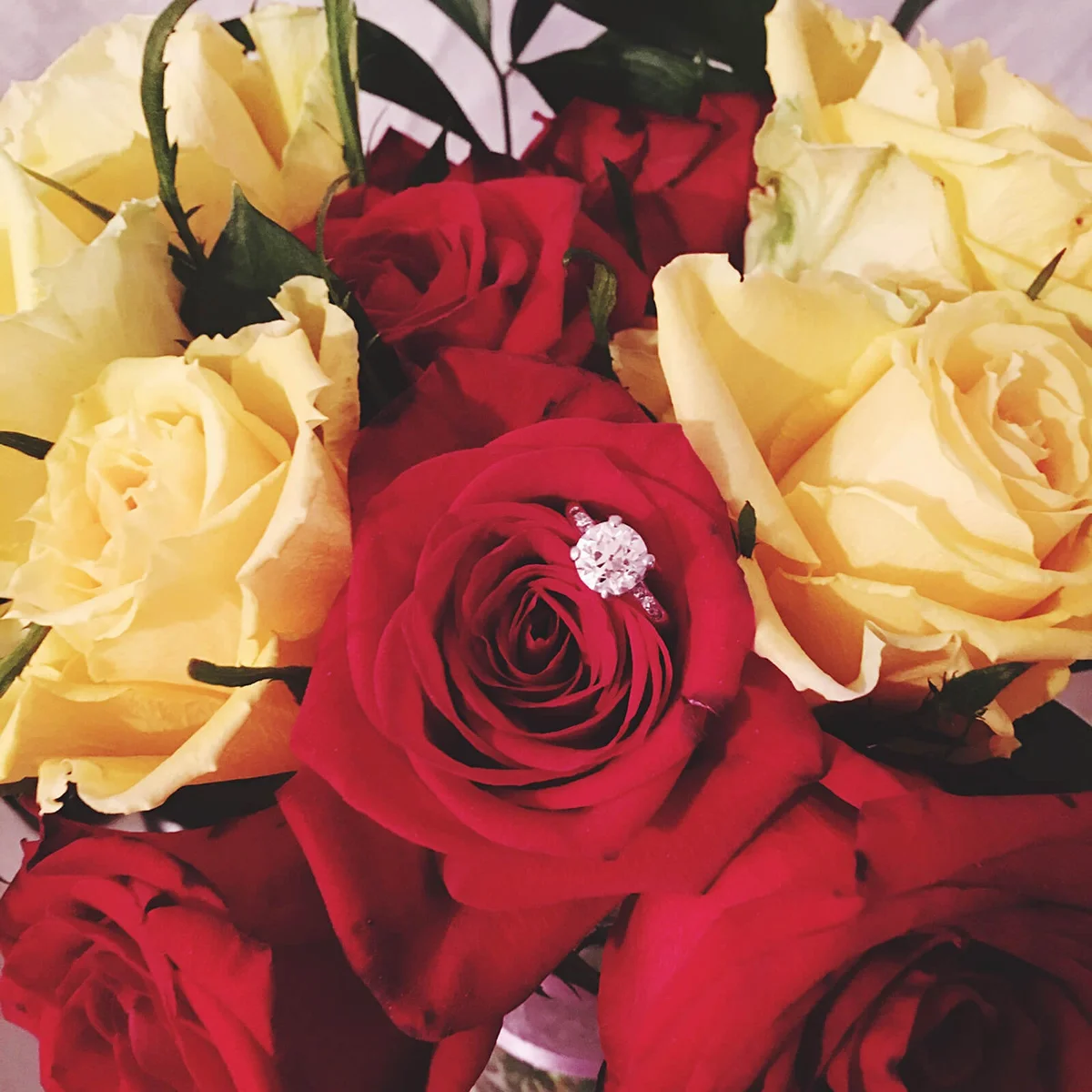 Close-Up Of Wedding Ring On Rose Bouquet