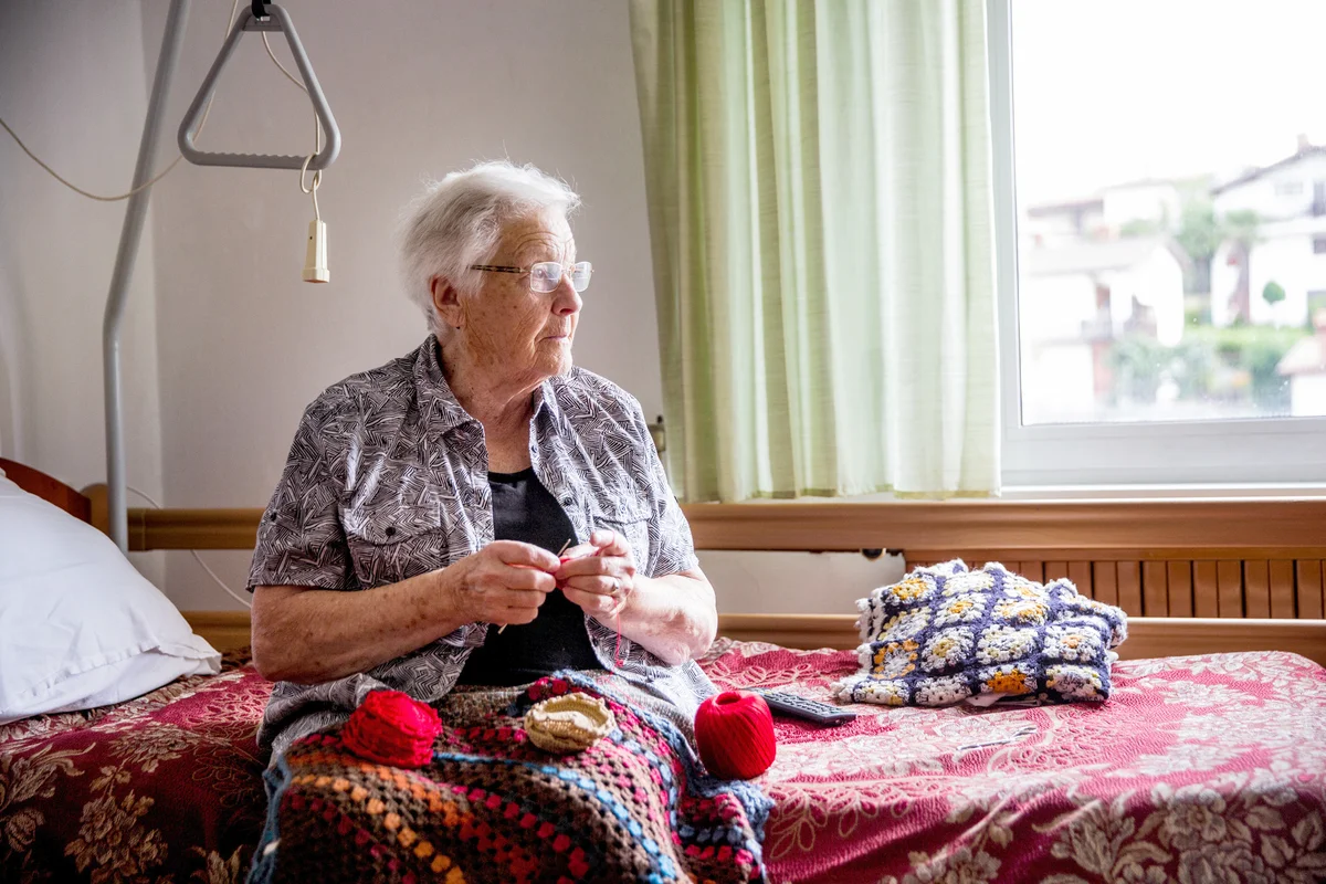 Senior Lady Crocheting in Her Room in Retire Community