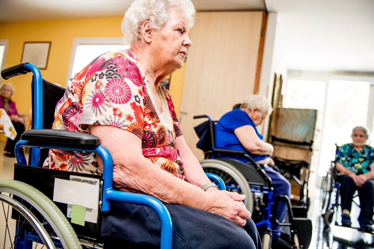 Seniors On The Wheelchair Attend In The Retirement Home