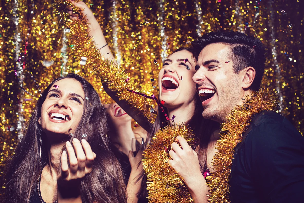 Happy people enjoing the party with confetti