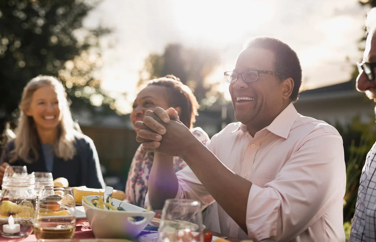man enjoying garden party lunch with friends