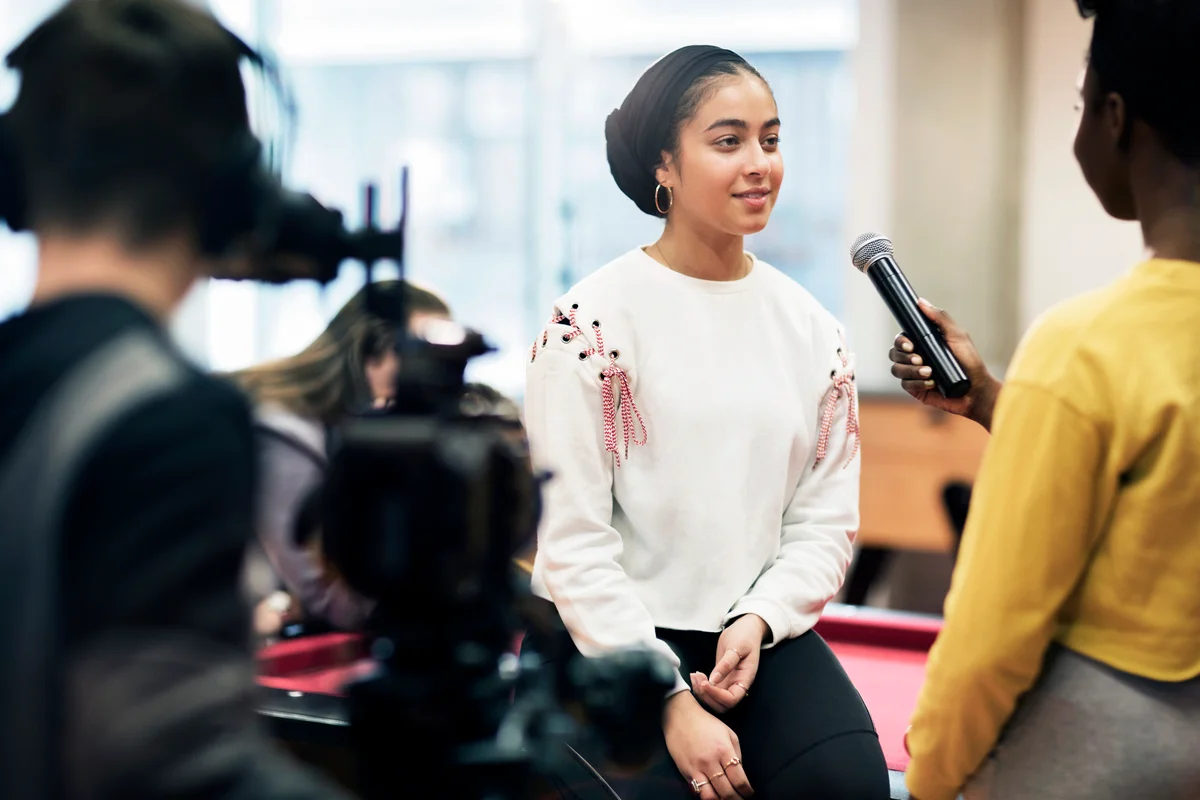Teenagers with microphone and video camera