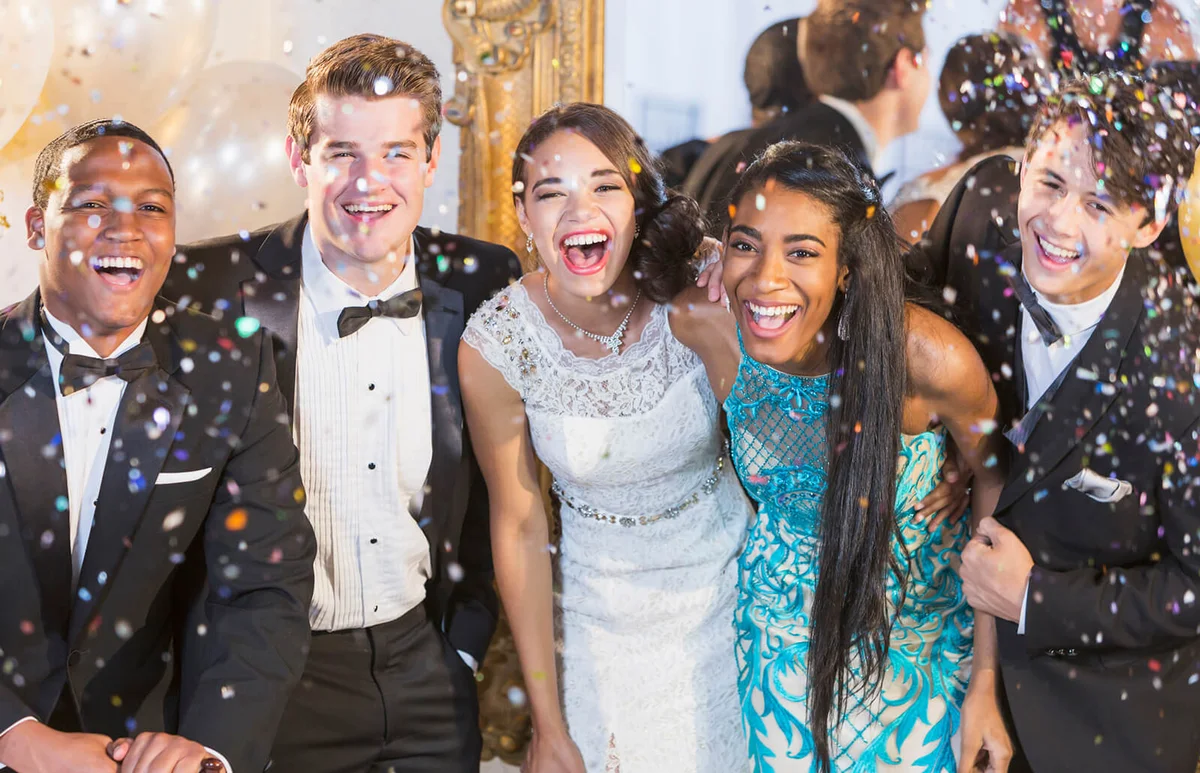 Teenagers in formalwear at school dance