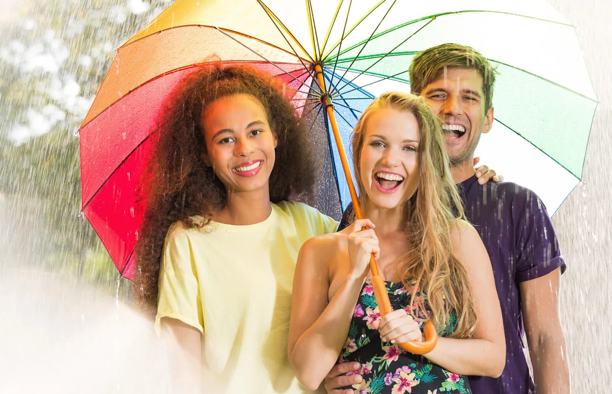 Happy friends under umbrella