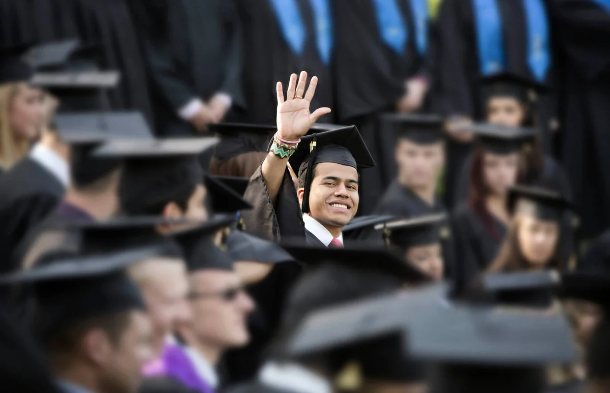 High school graduate waving