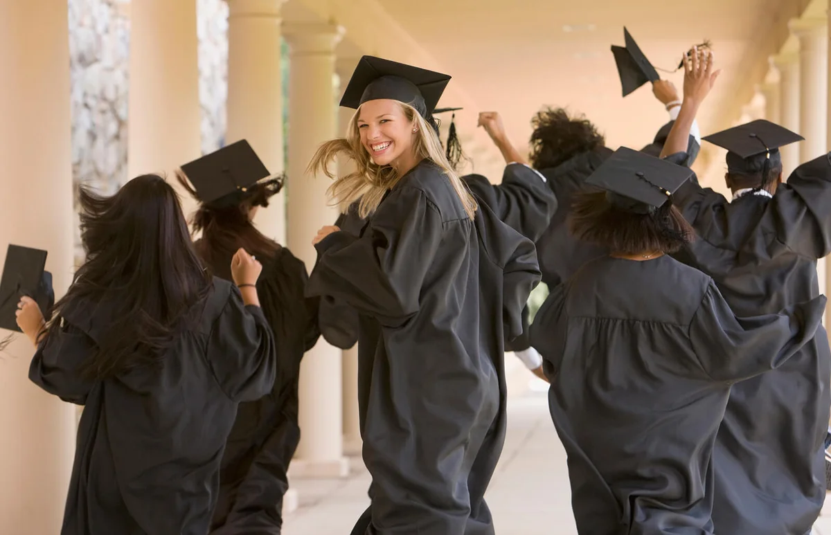 Excited graduating students in caps and gowns