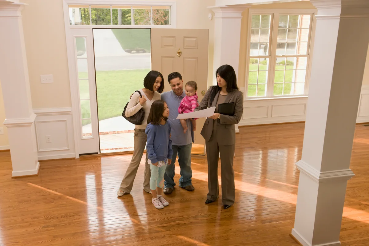 Family examining floor plan