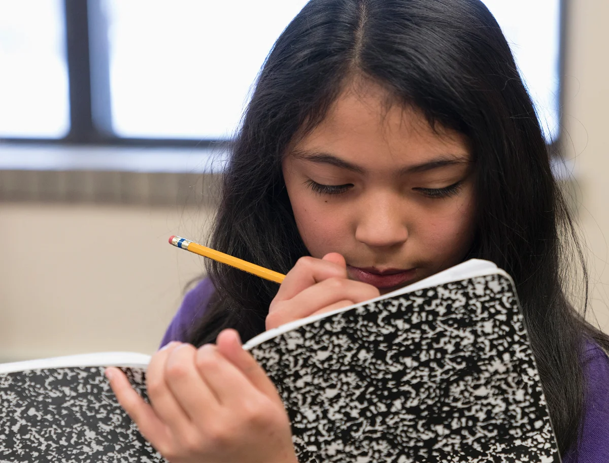 Girl writing in journal