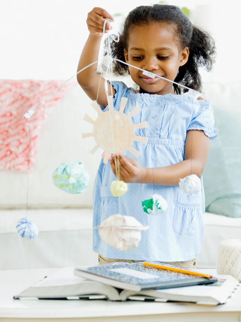 Girl with homemade mobile