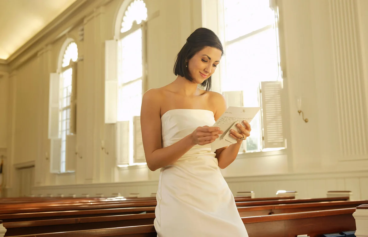 Bride reading letter in church