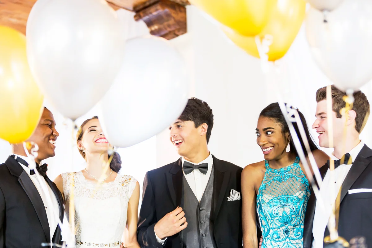 Teenagers in formalwear at party