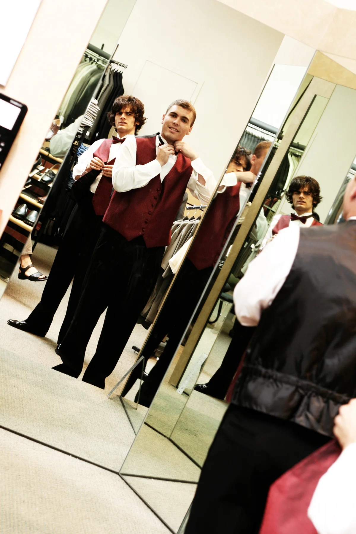 Young men trying on tuxedos