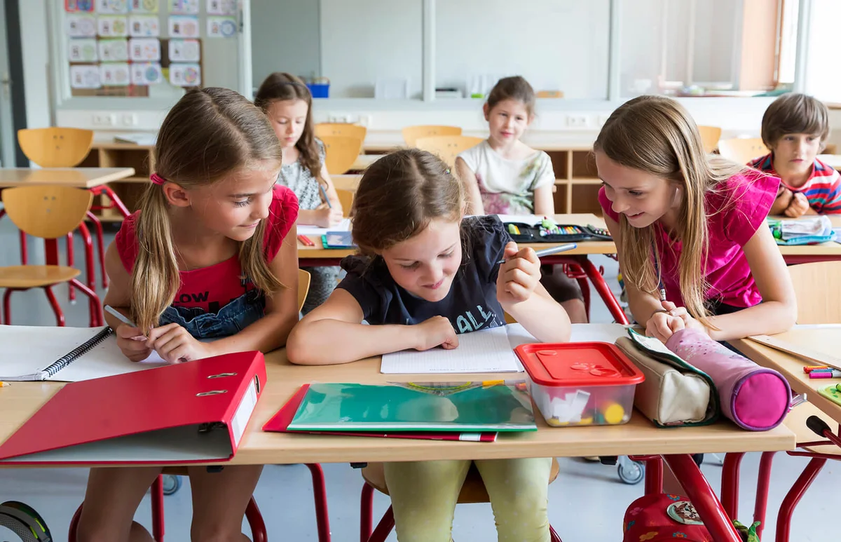 Three schoolgirls at class