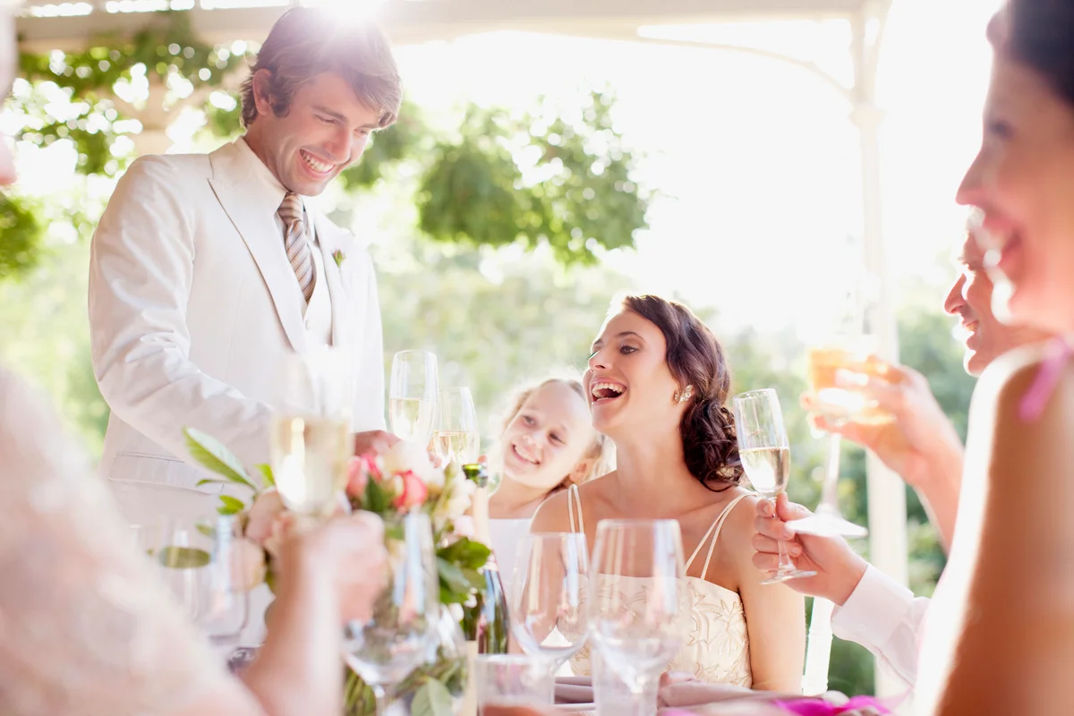 Groom giving toast at wedding reception