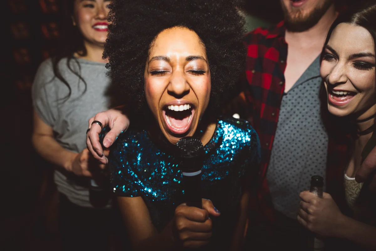 Group of women singing karaoke