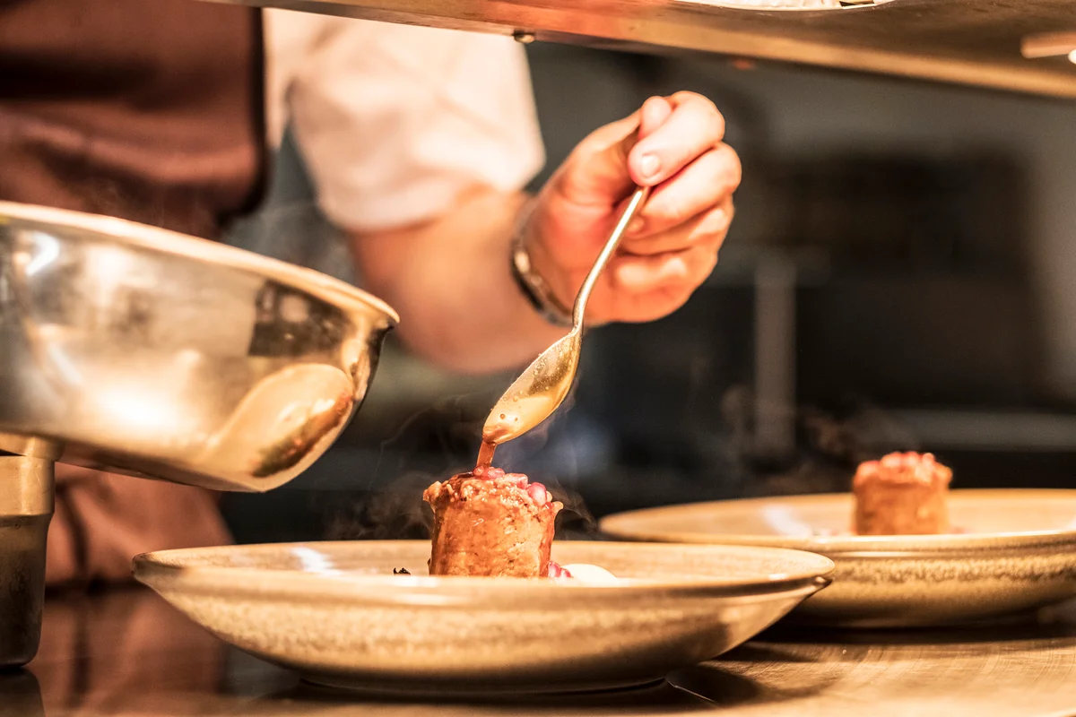 Chef saucing a filet