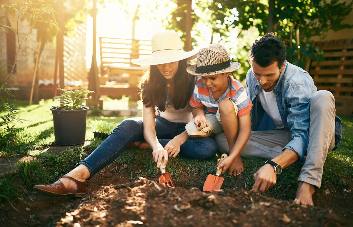 family gardening together in their backyard