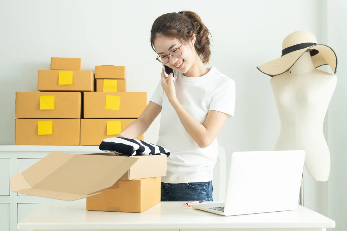 Teen packing boxes with sweater