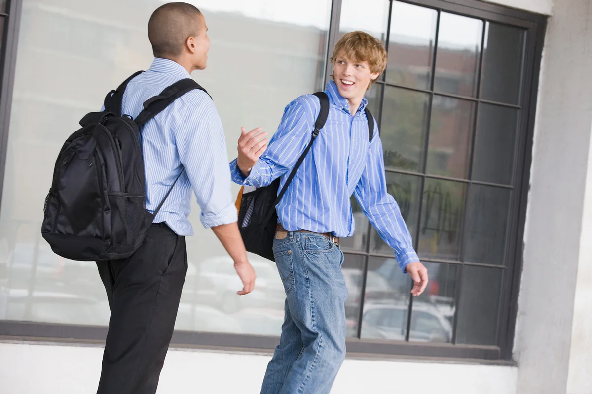 teen boys carrying backpacks