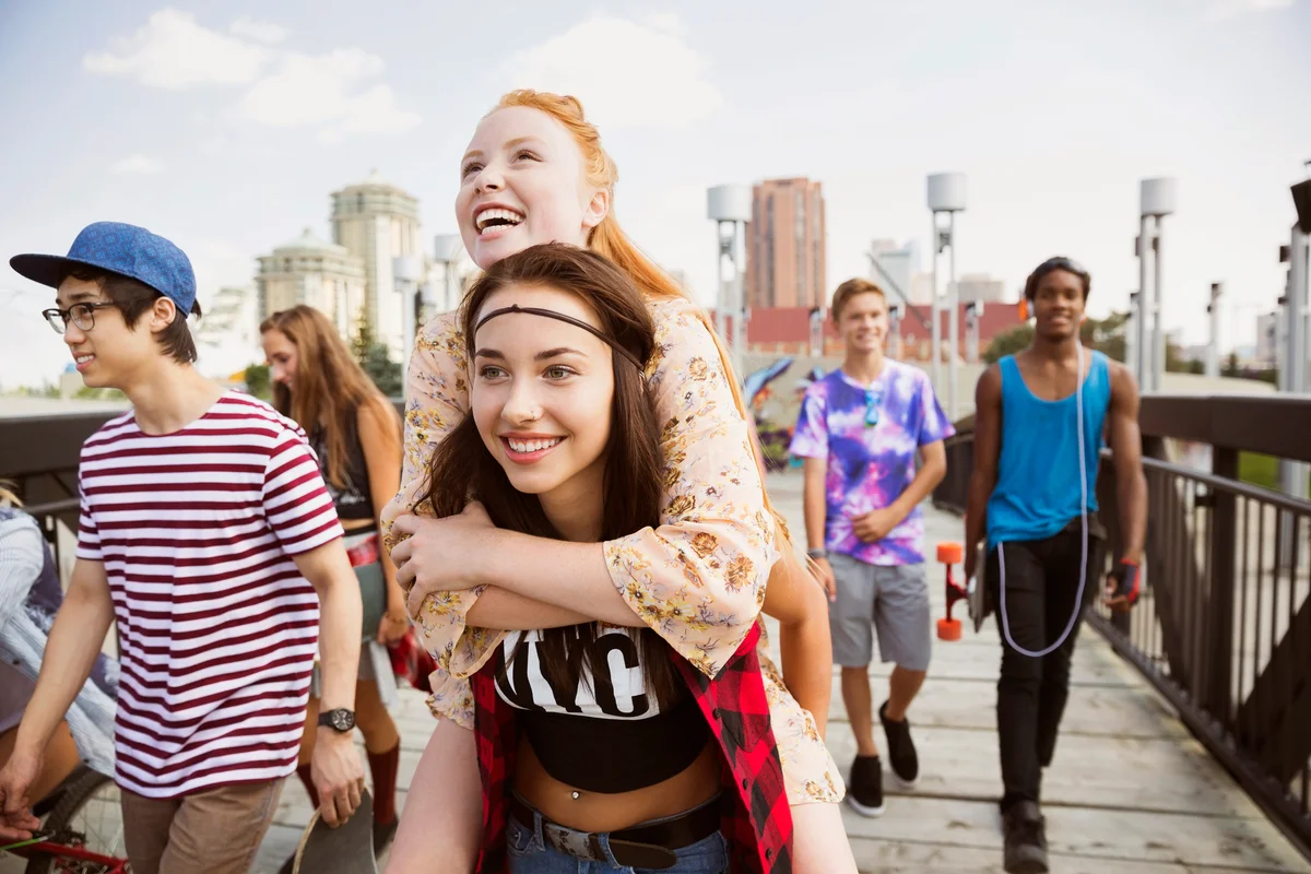 Enthusiastic teenagers on footbridge