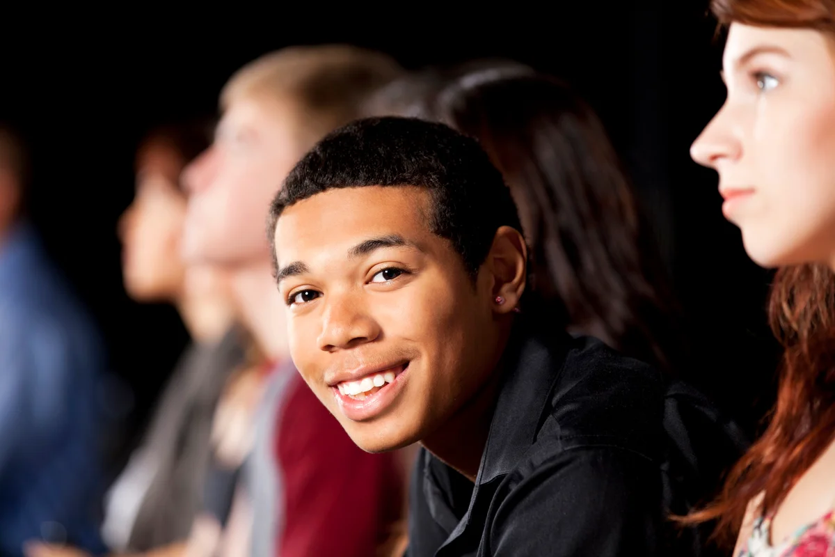 Happy teenager among his peers