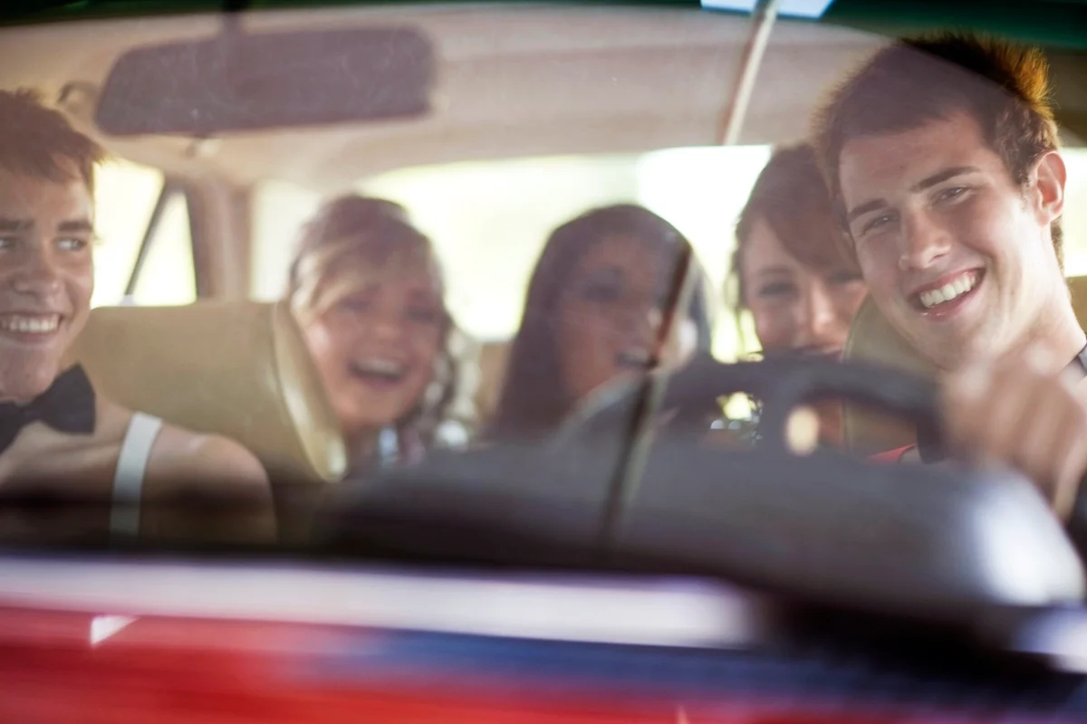 Teenagers driving in formal wear