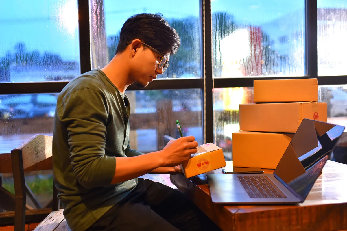 Teen packing boxes to mail