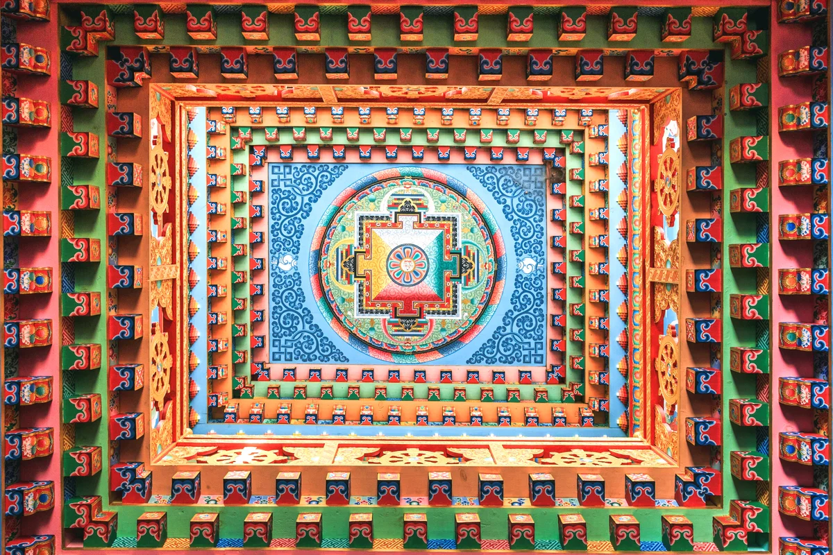 Highly decorated ceiling with mandala on the top center, inside the Tibetan buddhist monastery in upper Pisang