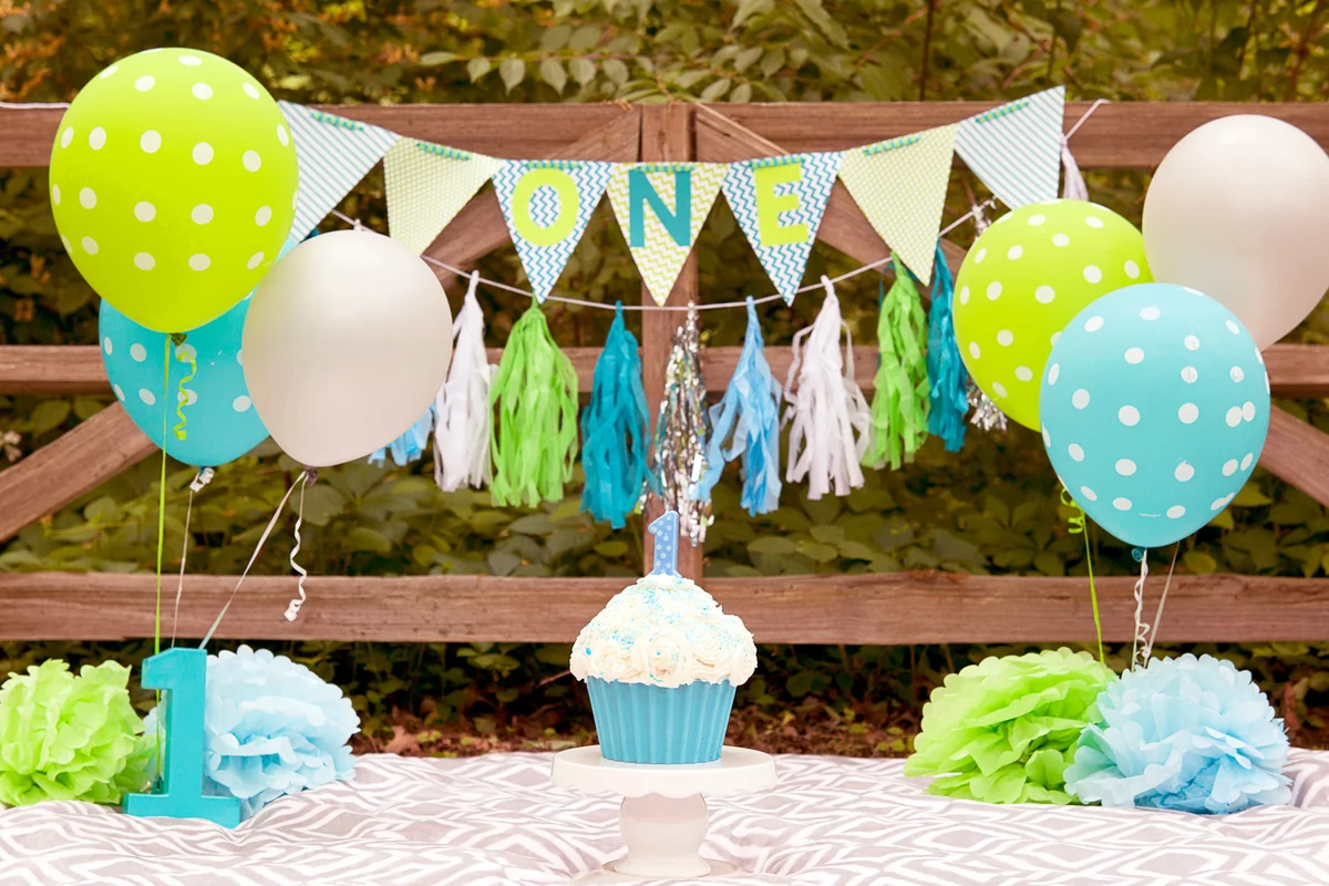 First Birthday scene for a child turning one. Banners, balloons, and cake and candle