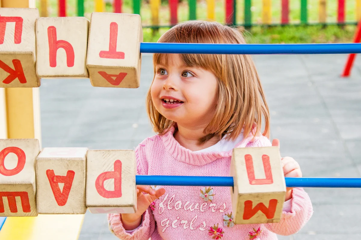 Girl Playing with Letters