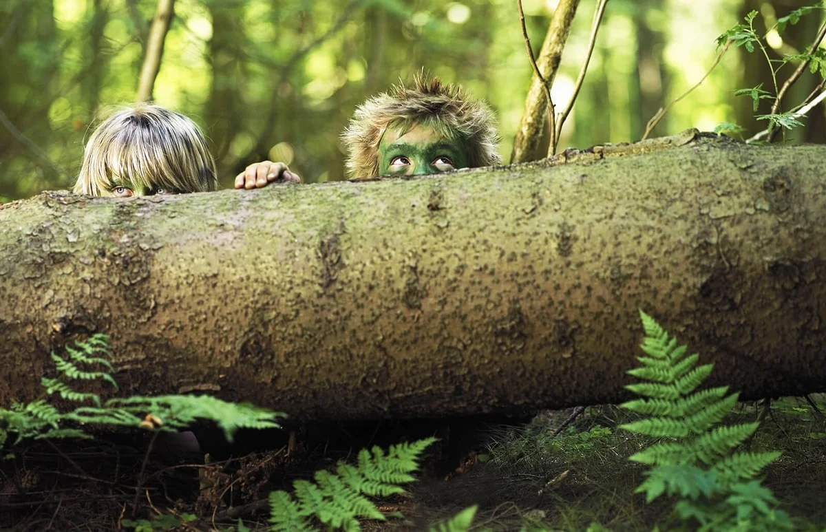 Boys hiding in the forest