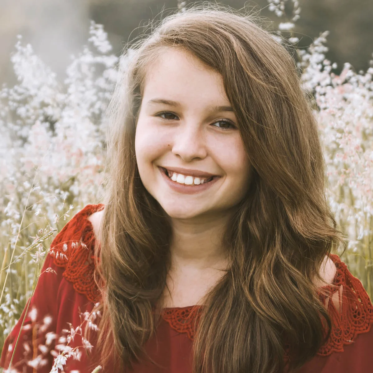 Portrait Of Cute Girl Smiling Against Plants