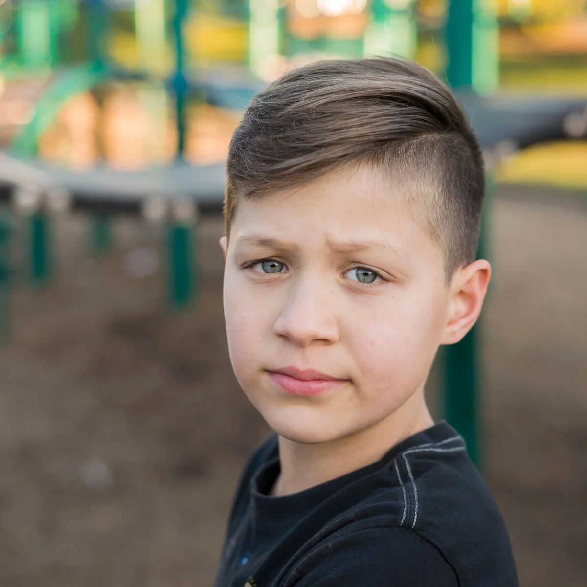 Portrait of sad boy at playground