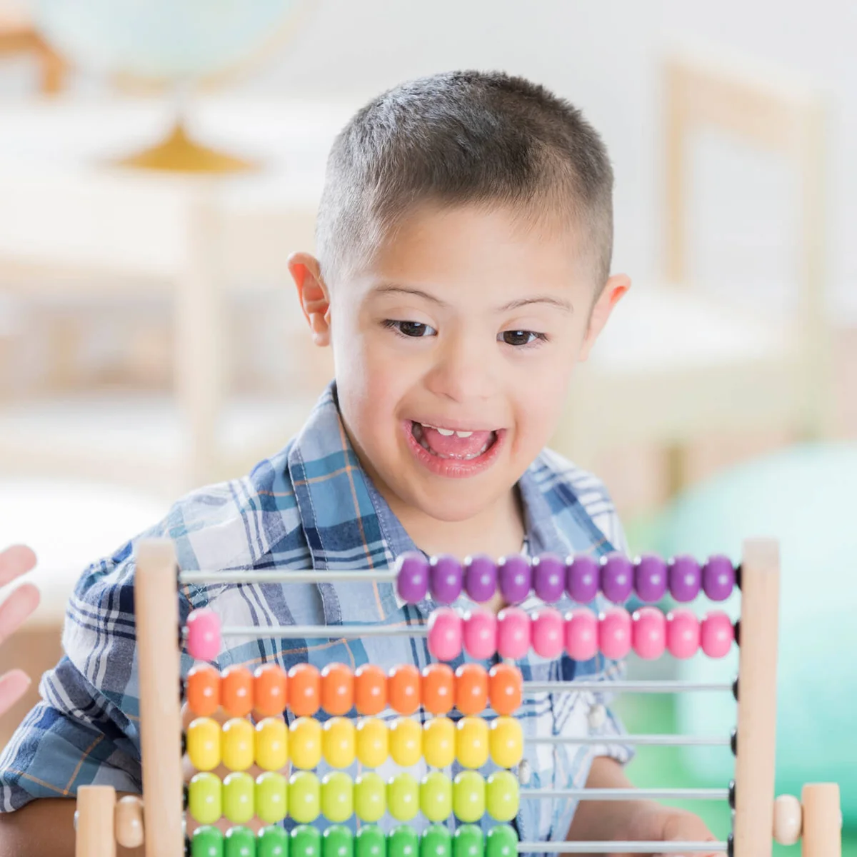 boy enjoys using abacus at school