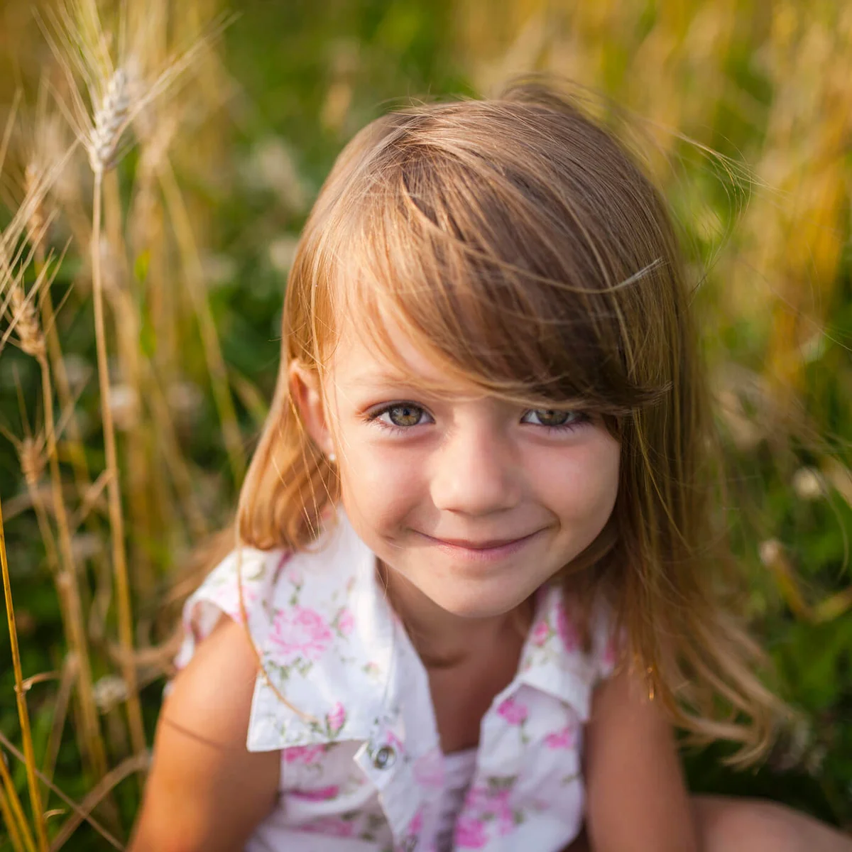 Portrait of happy girl sitting on farm