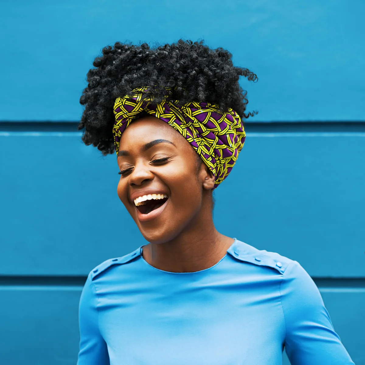 Joyous woman infront of wall