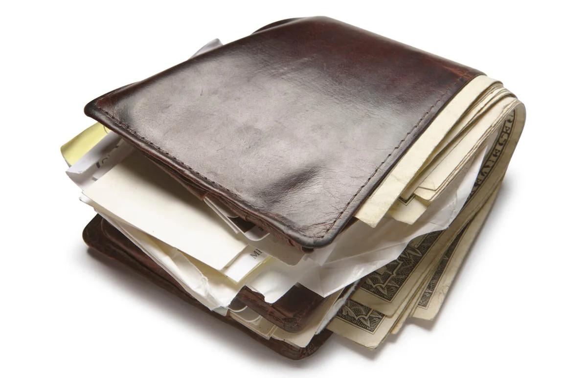 old wallet stuffed with money and papers